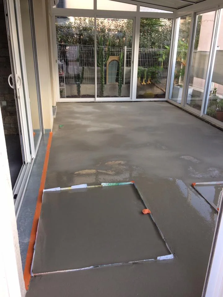 Préparation du sol avec chape liquide autolissante avant pose de revêtement.